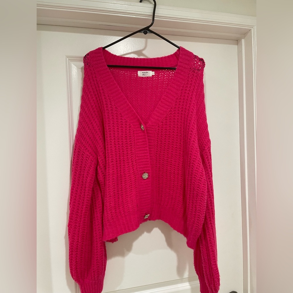Bright pink sweater with jewel buttons